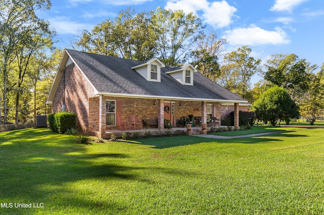 cape cod-style house featuring a front yard, covered porch, and central air condition unit