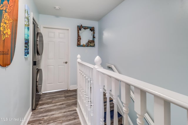 1664 Beach Blvd Unit 172, Biloxi, MS 39531 - hall with stacked washer / drying machine, an upstairs landing, and dark wood finished floors