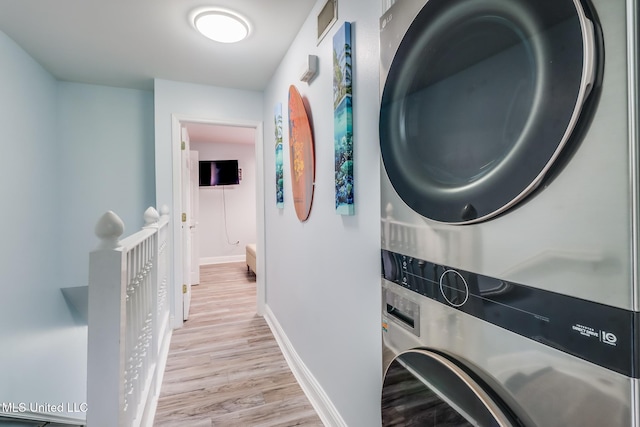 1664 Beach Blvd Unit 172, Biloxi, MS 39531 - washroom featuring stacked washer / drying machine and light wood-type flooring