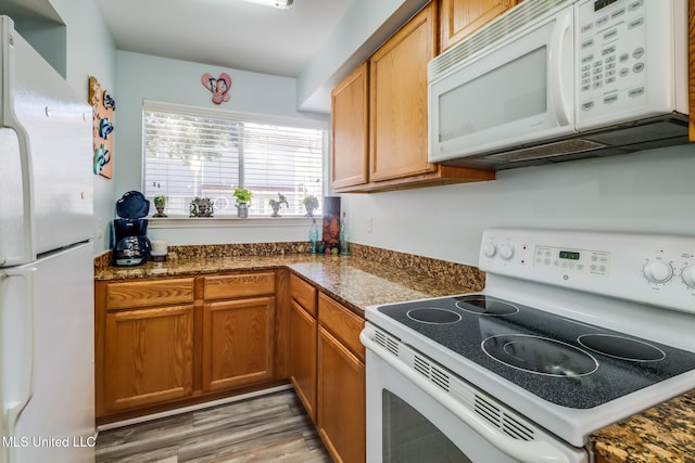 1664 Beach Blvd Unit 172, Biloxi, MS 39531 - kitchen featuring white appliances, brown cabinets, dark countertops, and light wood-style flooring