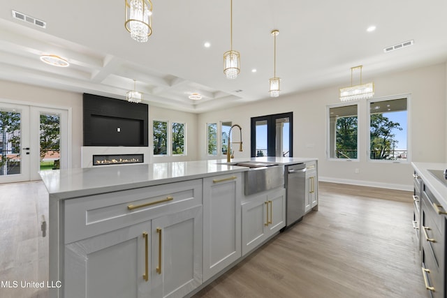 kitchen with french doors, light hardwood / wood-style flooring, plenty of natural light, and coffered ceiling