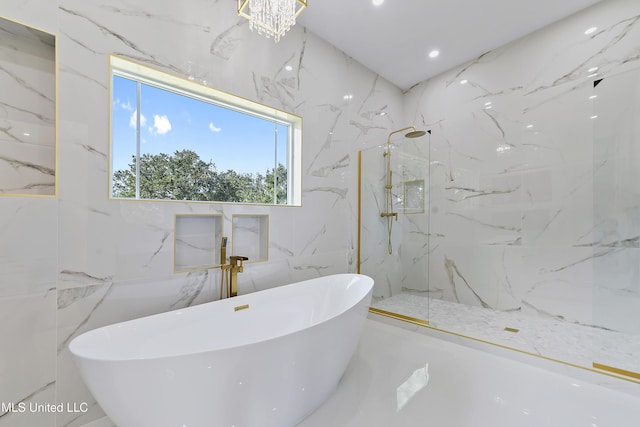 bathroom with tile walls, plus walk in shower, and an inviting chandelier