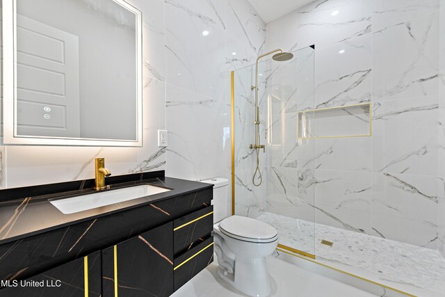 bathroom featuring vanity, toilet, and a tile shower