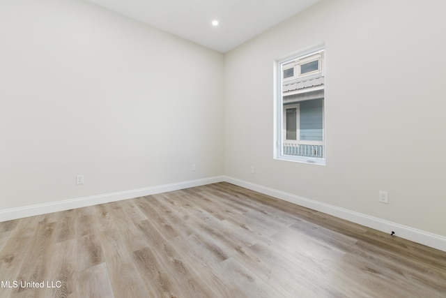 unfurnished room with light wood-type flooring