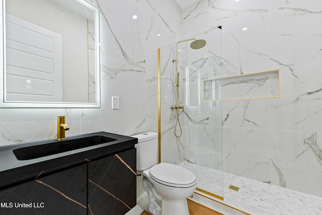 bathroom with vanity, toilet, and a tile shower