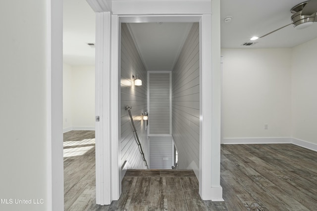 interior space featuring a ceiling fan, visible vents, wood finished floors, and baseboards