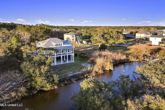 aerial view featuring a view of trees and a water view