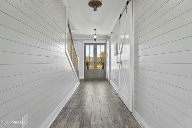 corridor featuring stairs, dark wood-style floors, baseboards, and french doors