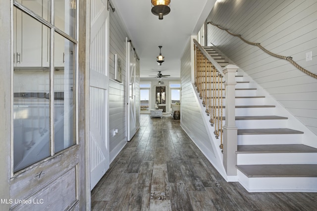 foyer entrance featuring dark wood-type flooring and stairs