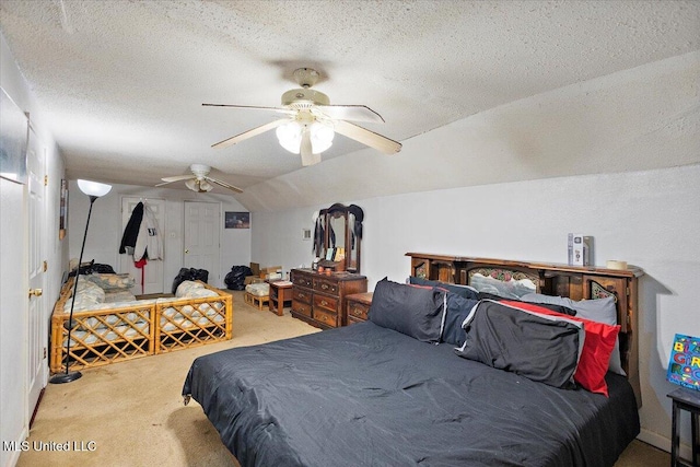 bedroom with lofted ceiling, ceiling fan, a textured ceiling, and carpet flooring