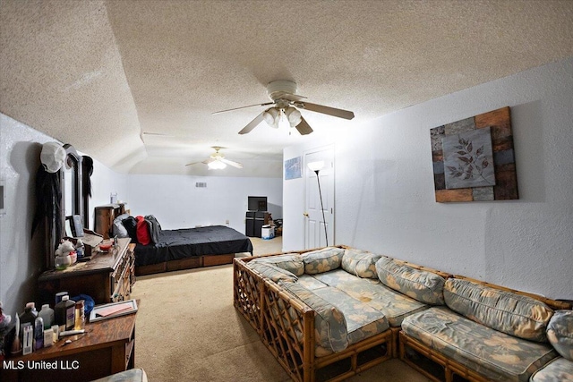 carpeted bedroom with ceiling fan and a textured ceiling