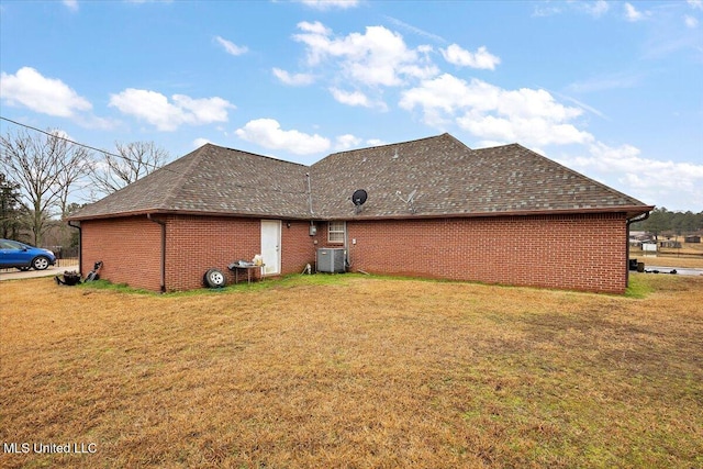 view of property exterior with cooling unit and a lawn