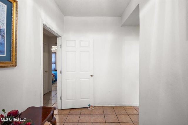 corridor featuring light tile patterned floors