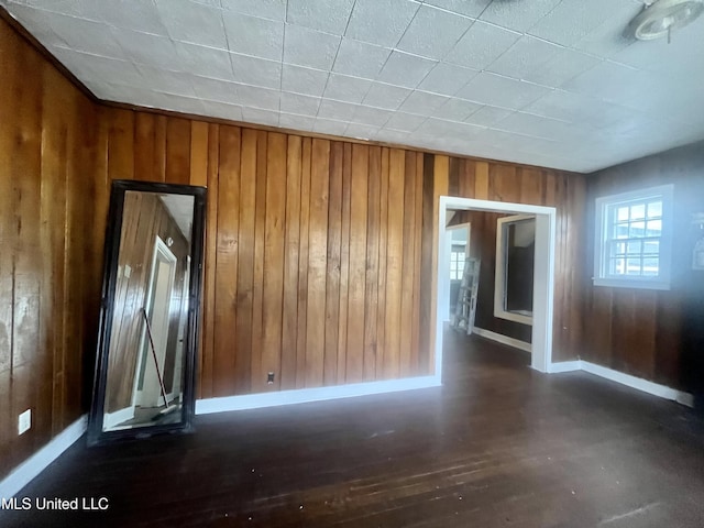 1289 S St, Grenada, MS 38901 - spare room featuring wooden walls, wood finished floors, and baseboards