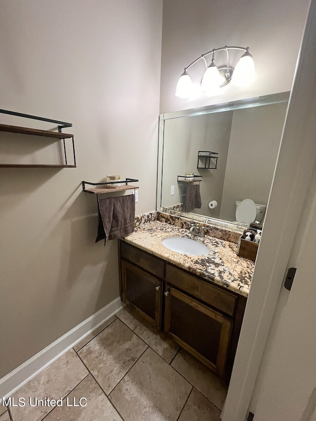 bathroom featuring vanity, toilet, and tile patterned floors