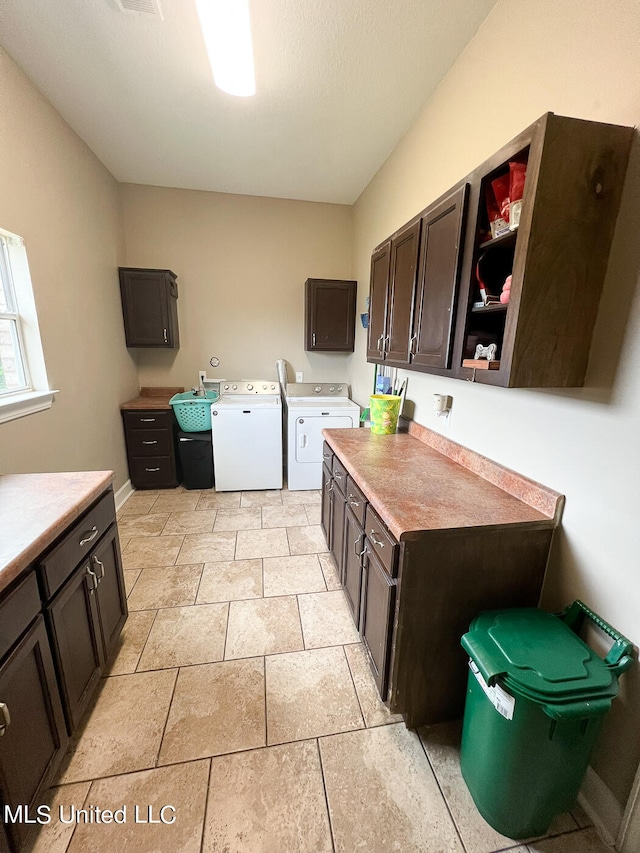 kitchen featuring dark brown cabinets and washing machine and dryer