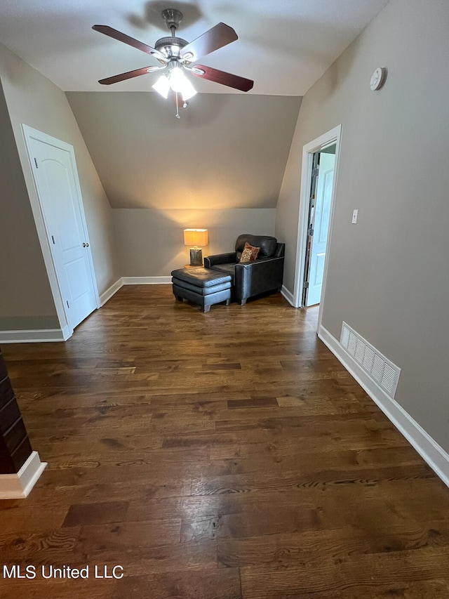 bonus room with dark hardwood / wood-style floors and vaulted ceiling