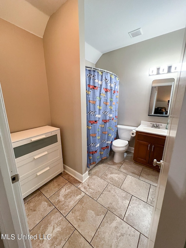 bathroom featuring tile patterned floors, toilet, a shower with curtain, vaulted ceiling, and vanity