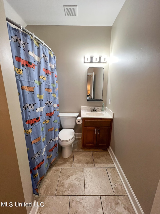 bathroom with vanity, toilet, curtained shower, and tile patterned flooring