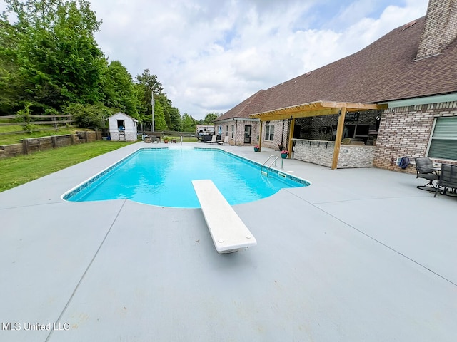 view of swimming pool featuring a patio and a diving board