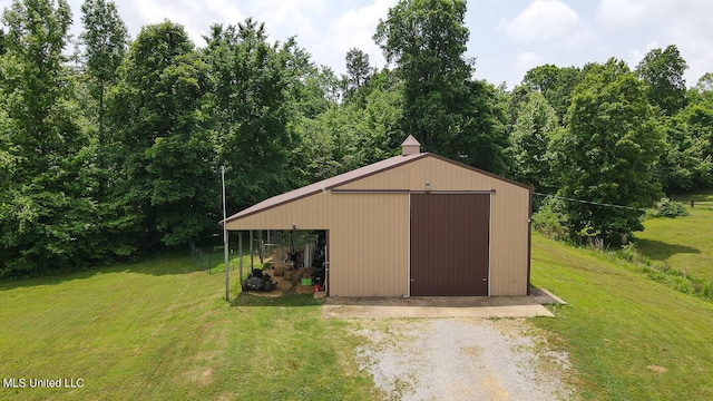 view of outdoor structure featuring a yard and a garage