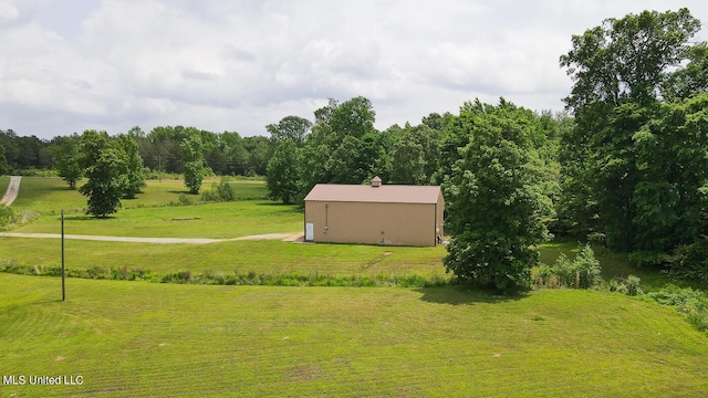 view of yard with a rural view and an outdoor structure