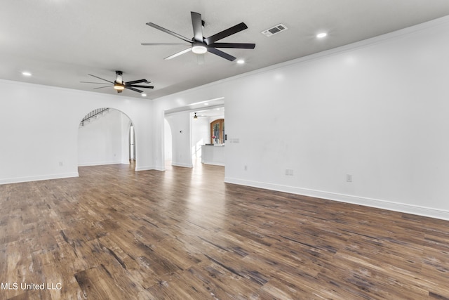 10186 Wire Rd, Vancleave, MS 39565 - unfurnished living room featuring arched walkways, ornamental molding, a ceiling fan, dark wood-style flooring, and recessed lighting