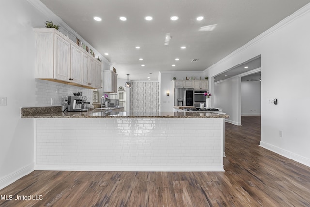 10186 Wire Rd, Vancleave, MS 39565 - kitchen with stainless steel fridge with ice dispenser, ornamental molding, a peninsula, dark stone countertops, and decorative backsplash