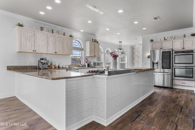 10186 Wire Rd, Vancleave, MS 39565 - kitchen featuring stainless steel appliances, crown molding, recessed lighting, tasteful backsplash, and dark stone counters