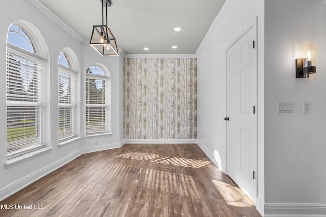 10186 Wire Rd, Vancleave, MS 39565 - unfurnished dining area featuring baseboards, crown molding, wood finished floors, recessed lighting, and an accent wall