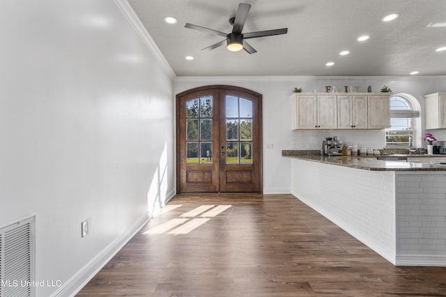 10186 Wire Rd, Vancleave, MS 39565 - kitchen with crown molding, arched walkways, dark wood-style flooring, baseboards, and tasteful backsplash
