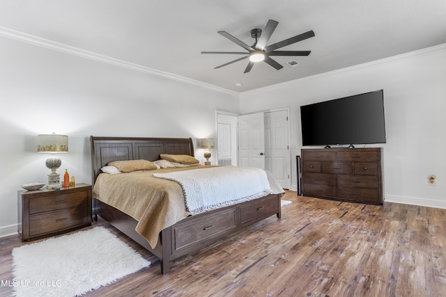 10186 Wire Rd, Vancleave, MS 39565 - bedroom featuring wood finished floors, crown molding, baseboards, and ceiling fan