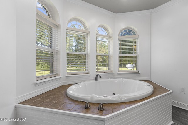 10186 Wire Rd, Vancleave, MS 39565 - bathroom featuring a jetted tub, crown molding, and baseboards