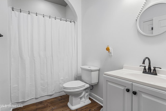 10186 Wire Rd, Vancleave, MS 39565 - full bathroom with toilet, wood finished floors, vanity, and baseboards