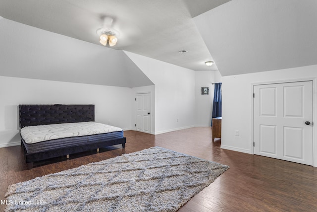 10186 Wire Rd, Vancleave, MS 39565 - bedroom with wood finished floors, lofted ceiling, and baseboards