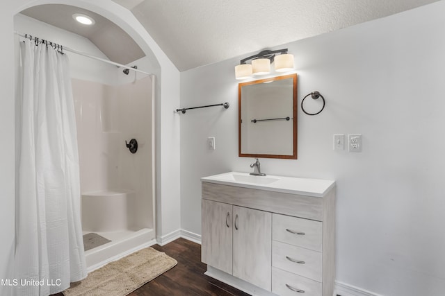 10186 Wire Rd, Vancleave, MS 39565 - bathroom featuring a shower with curtain, wood finished floors, baseboards, vanity, and lofted ceiling