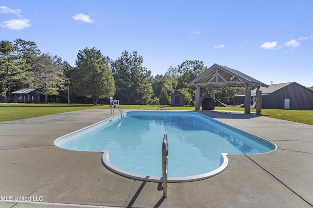 10186 Wire Rd, Vancleave, MS 39565 - swimming pool with a storage unit, an outdoor structure, a lawn, and a gazebo