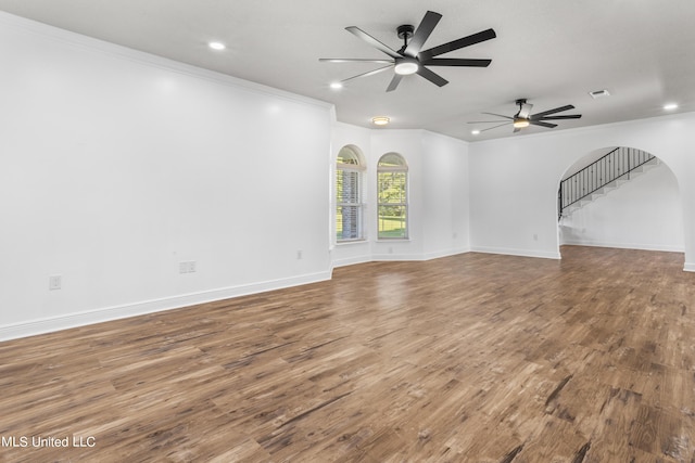 10186 Wire Rd, Vancleave, MS 39565 - unfurnished living room featuring ornamental molding, a ceiling fan, wood finished floors, arched walkways, and recessed lighting