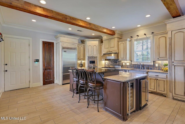 105 Victoria Pl, Madison, MS 39110 - kitchen with beam ceiling, backsplash, appliances with stainless steel finishes, a kitchen breakfast bar, and wine cooler