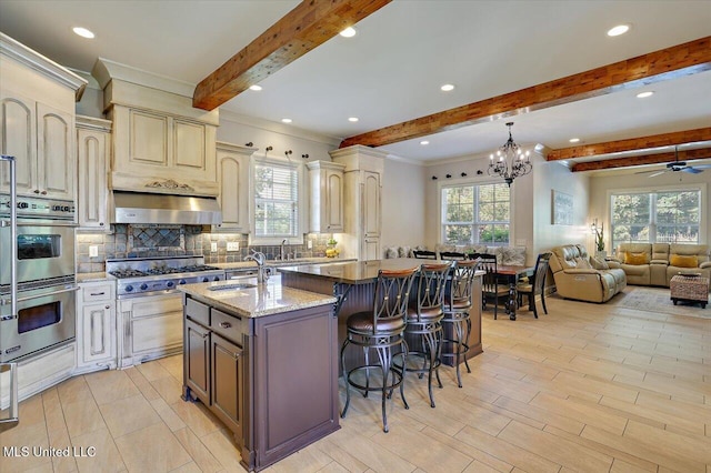 105 Victoria Pl, Madison, MS 39110 - kitchen featuring stainless steel appliances, beam ceiling, plenty of natural light, backsplash, and recessed lighting