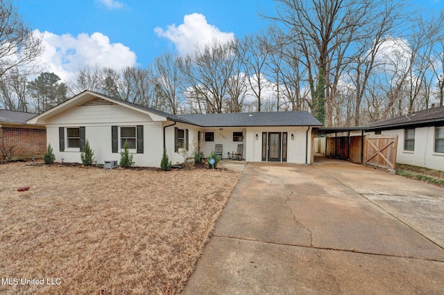 ranch-style home featuring a carport