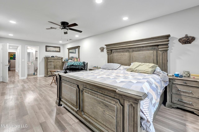 bedroom featuring connected bathroom, light hardwood / wood-style floors, and ceiling fan