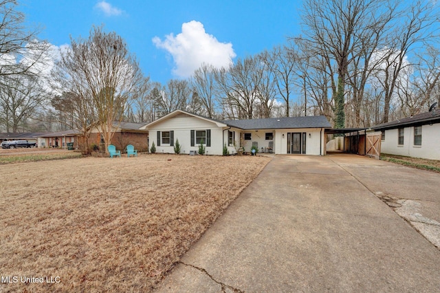 ranch-style home with a carport and a front yard