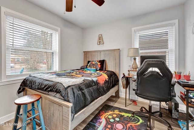 bedroom with hardwood / wood-style flooring and ceiling fan