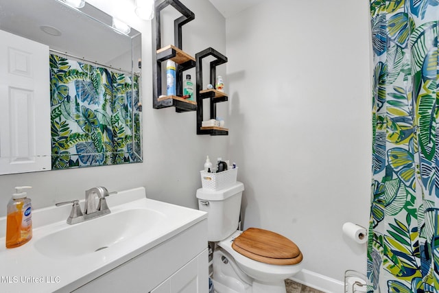 bathroom with vanity, curtained shower, and toilet