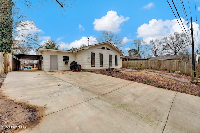 back of house featuring a carport