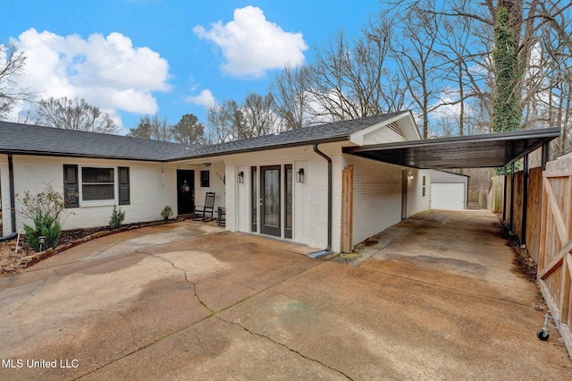 rear view of house featuring a carport and a garage