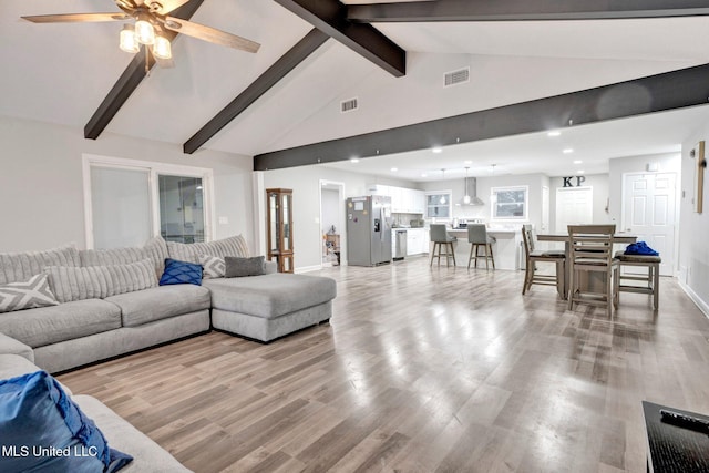 living room featuring beamed ceiling, ceiling fan, high vaulted ceiling, and light hardwood / wood-style floors