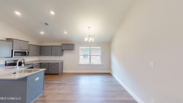 7908 Gardendale Dr, Olive Branch, MS 38654 - kitchen with lofted ceiling, stainless steel appliances, a sink, and gray cabinets
