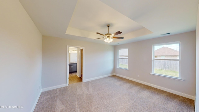 7908 Gardendale Dr, Olive Branch, MS 38654 - unfurnished room with a tray ceiling, visible vents, baseboards, and light carpet